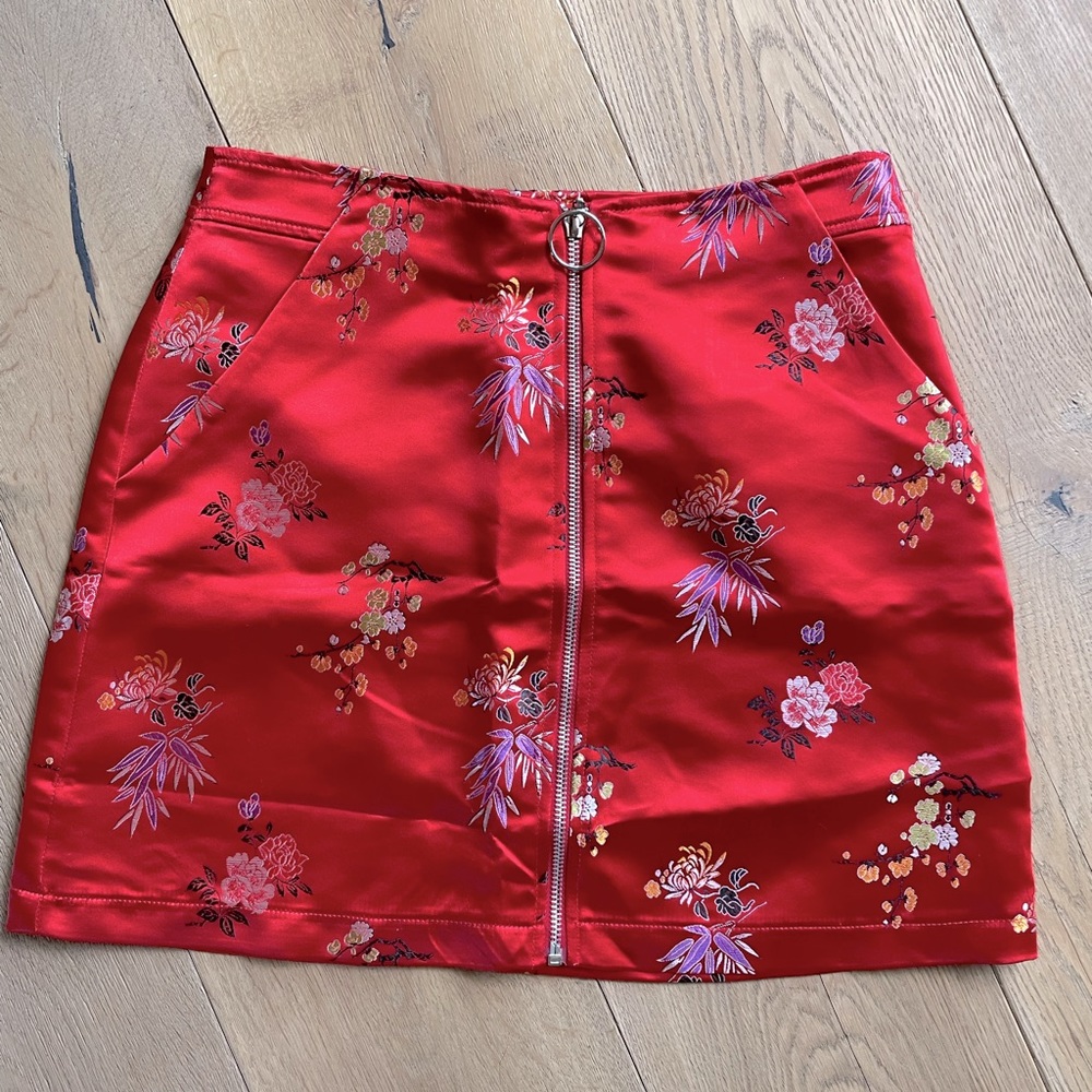 Short embroidered red satin skirt